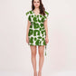 Full front view of model wearing sleeveless green wrap dress with belt tie-up and abstract pattern.