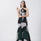 Model wearing an ankle-length halter neck crepe dress with green, black, and grey abstract print on white base.