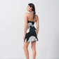 Rear view highlighting halter tie-back and back fit of green and black abstract print dress.