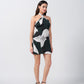 Full-length front view of model wearing green, grey, and black abstract short dress