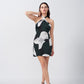  Model with one hand raised, showcasing halter neckline and short length of the dress.