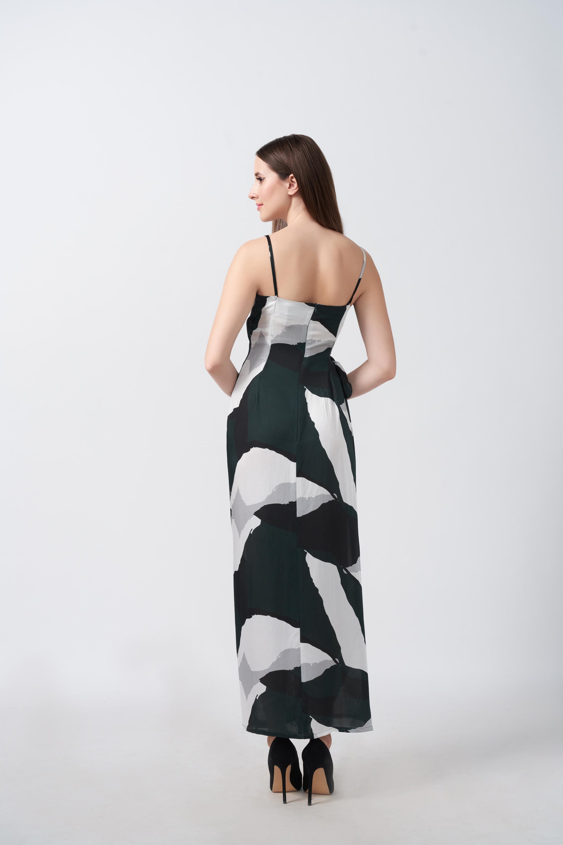 Rear view of the dress showing the tie-back and elegant fall of the abstract satin fabric.