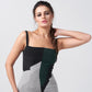 Close-up of square neckline and fitted bodice in abstract print crepe dress, capturing modern tailoring details.