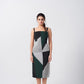 Model facing front in a green, black, and grey abstract print midi dress with square neckline, highlighting the structured silhouette.