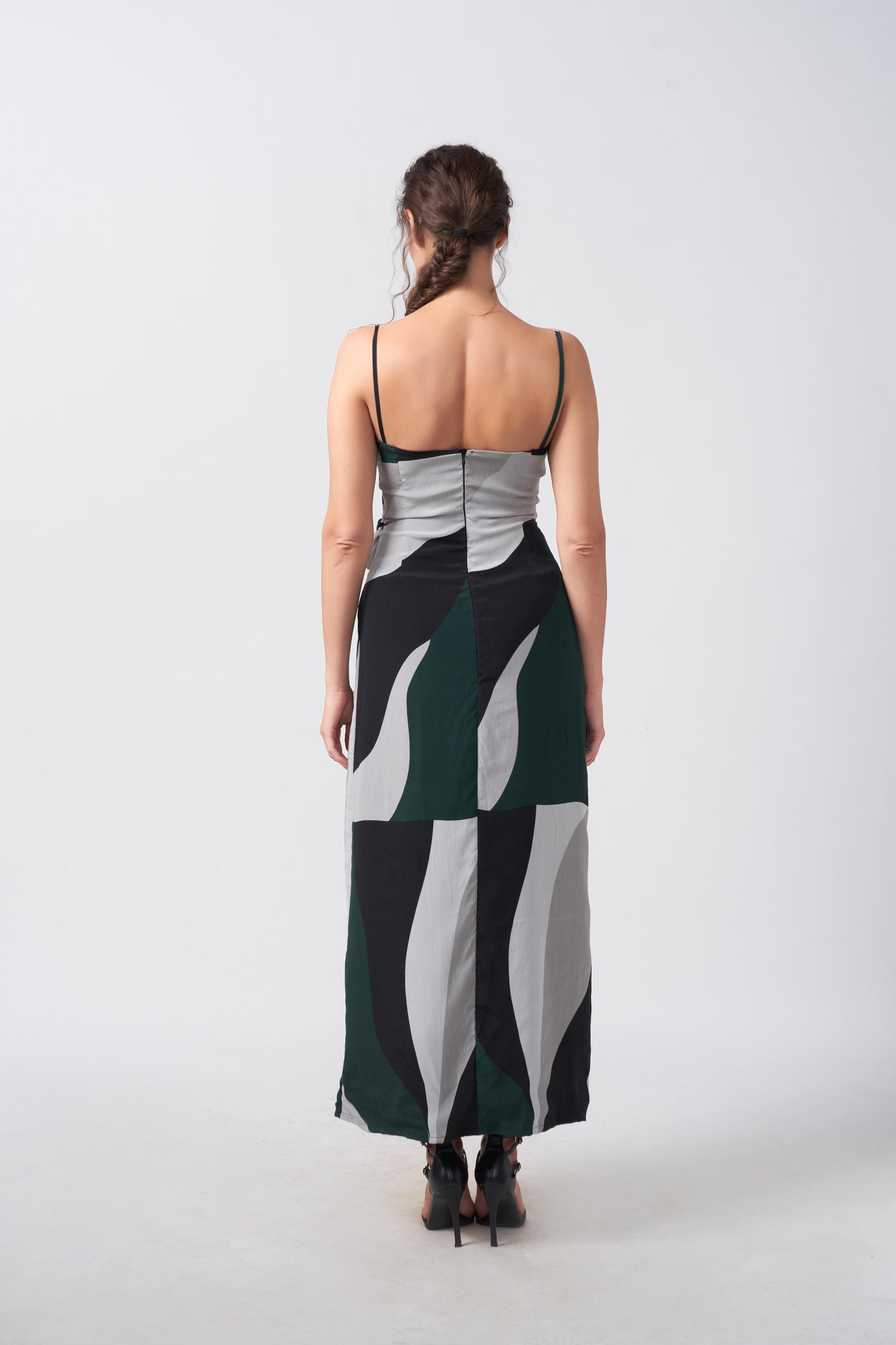 Rear view of green abstract print crepe dress, highlighting open-back and adjustable spaghetti strap design.