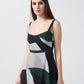 Close-up of the model in green, black, and grey midi dress highlighting neckline and print.