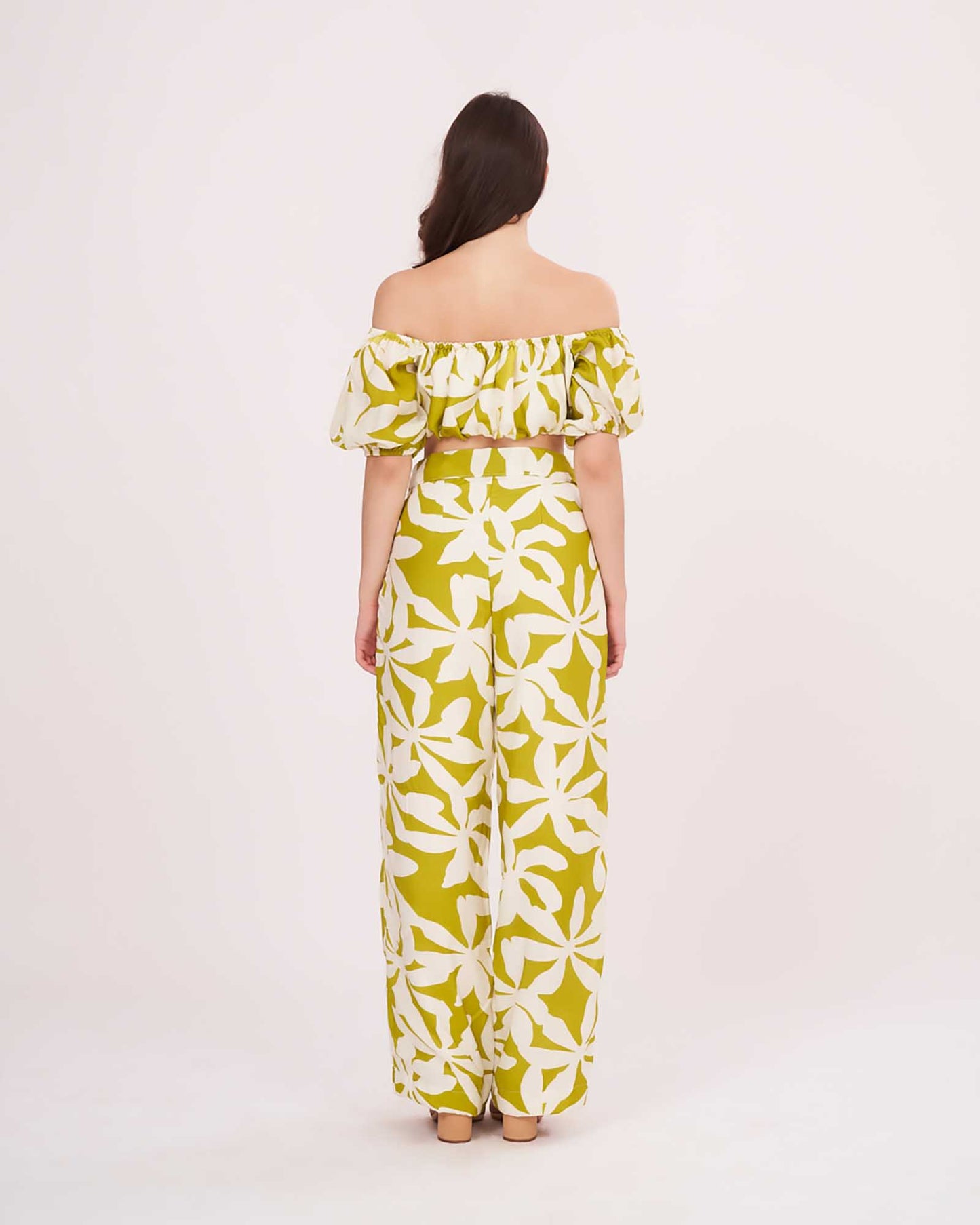Rear view of the outfit, showing the back fit of the off-shoulder crop top and the comfortable flow of the wide-leg printed pants.