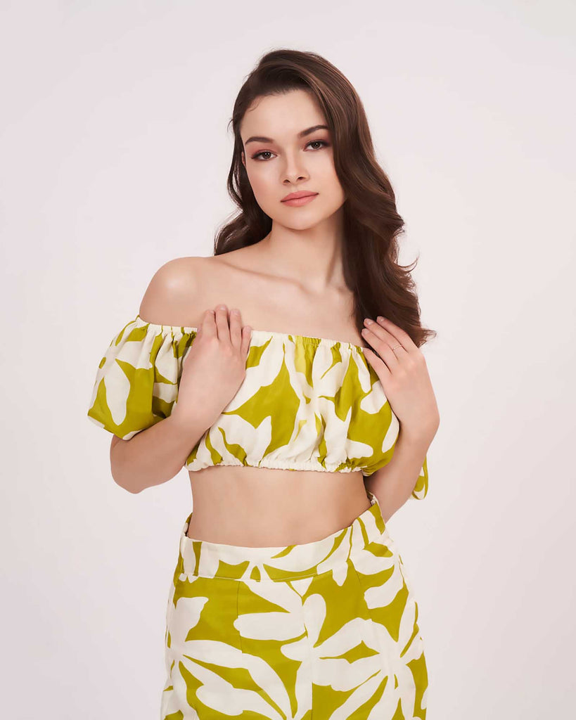 Zoomed-in front view showing the off-shoulder puff sleeves and ruched front detail of the green floral co-ord crop top.