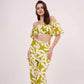 Model in a full standing pose facing forward, displaying the complete set with matching printed trousers and off-shoulder crop top