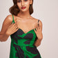 Close-up of green and black satin dress showing sweetheart neckline and delicate shoulder straps.