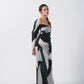 Full-length view showcasing the ankle-length flare and long sleeves of the abstract printed dress.