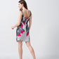 Back view of the model walking away in grey and white floral print dress, showing shoulder strap and hemline.