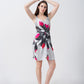 Model with arms raised above her head, highlighting the relaxed silhouette and shoulder strap details of the dress.