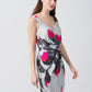 Side profile view of the model in grey abstract floral print short dress, emphasizing the drape and side cut.