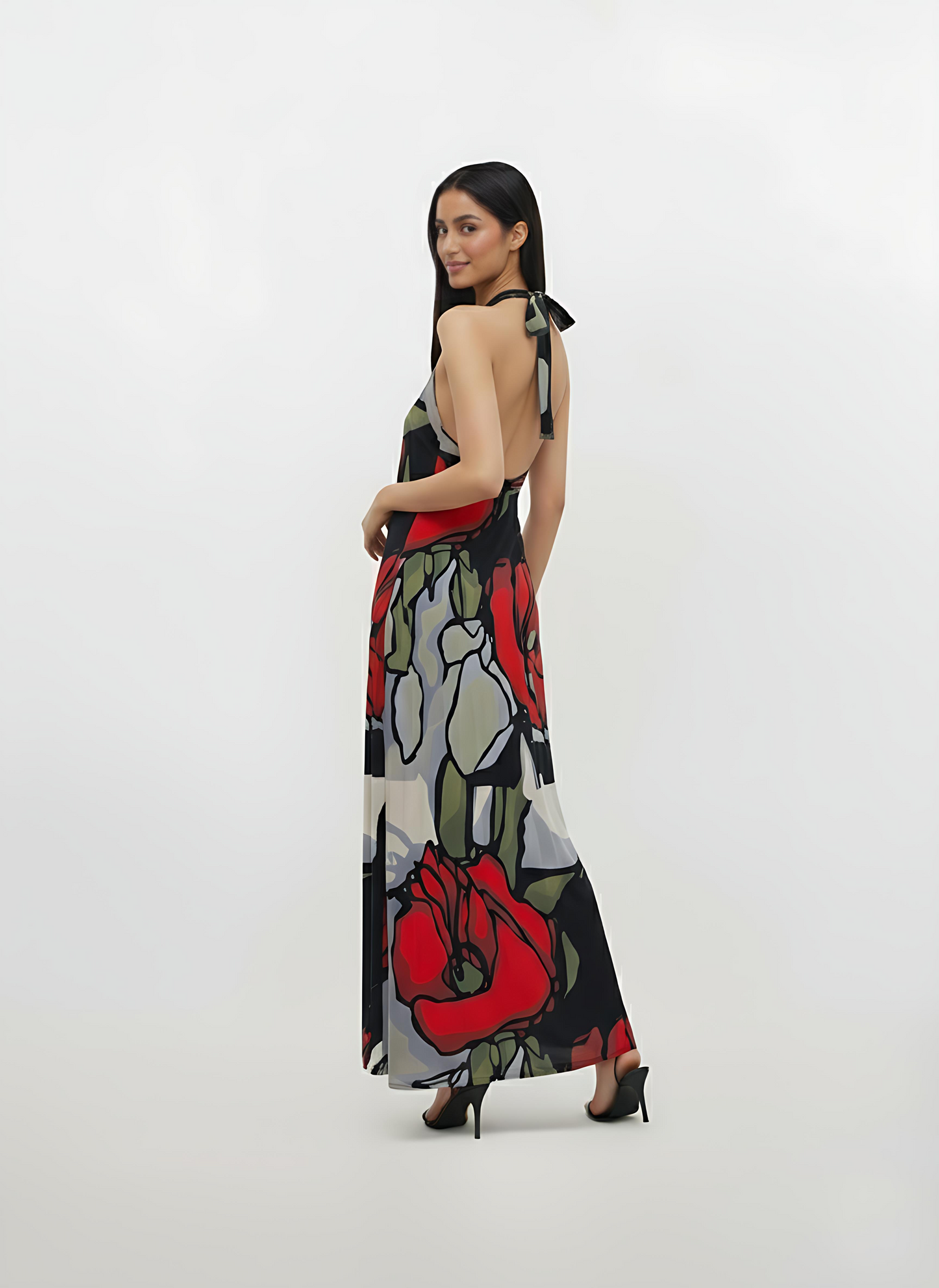 Backless long-line dress crafted from a lightweight, breathable fabric with thin straps, designed for graceful movement at the hem.