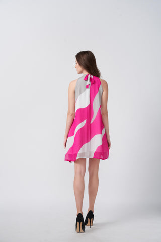 Back view of the model in pink and white halter dress, showcasing the tie-back detail and fit.