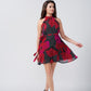 Red and pink abstract floral knee-length dress with a halter neckline, suitable for summer evenings and casual gatherings