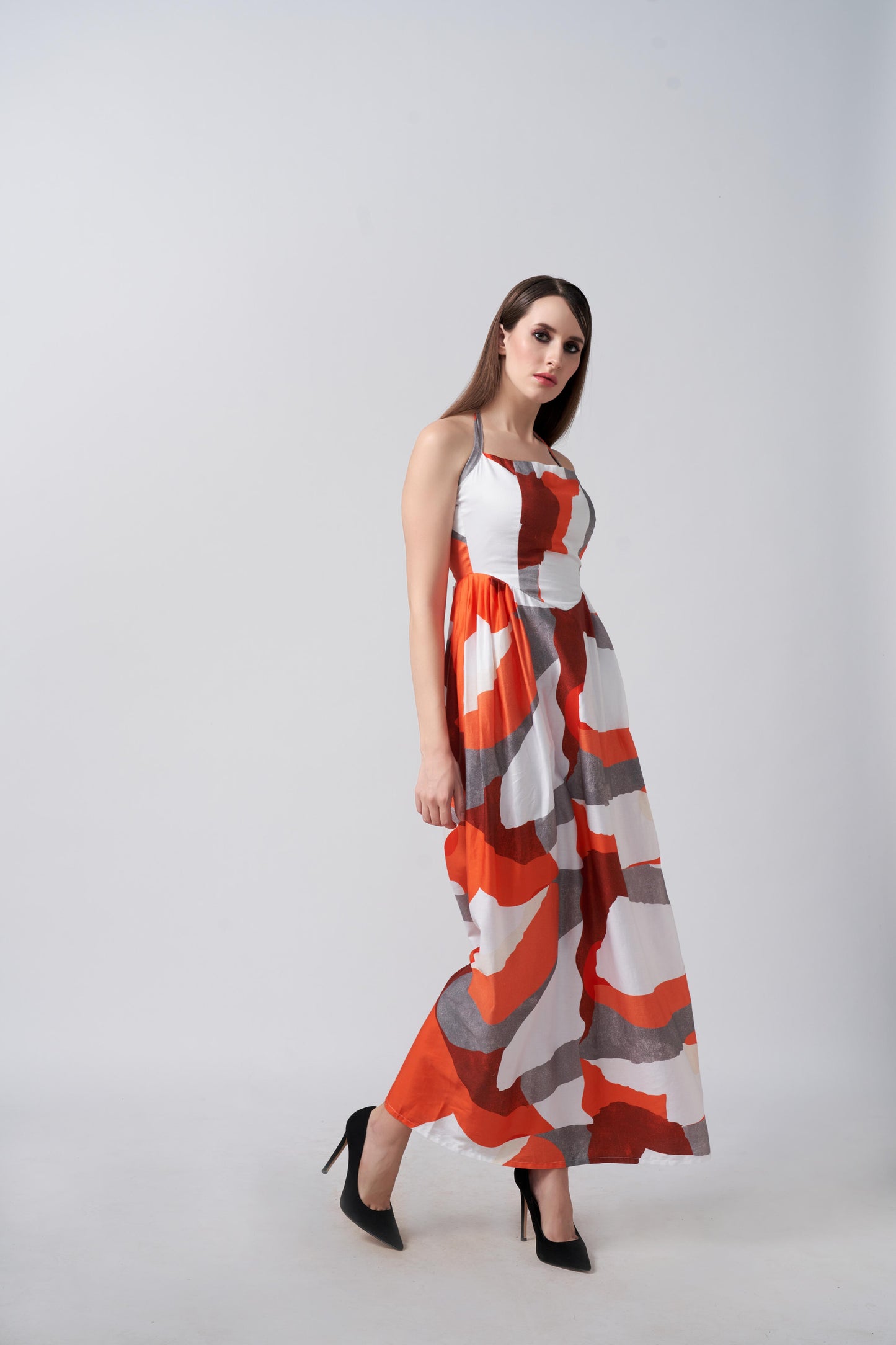 Orange and grey abstract print ankle-length dress with a halter neckline, ideal for casual evening outings and relaxed gatherings