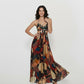 Long halter-neck dress with a bold, artistic pattern in shades of teal, brown, and black, ideal for tropical vacations, resort wear, or summer evening events.