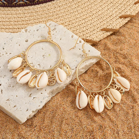 Imitation Gold Shell Drop Earrings featuring large circular metallic hoops with multiple dangling white cowrie shells and gold charms