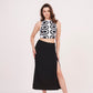 Square-shaped crop top with bold abstract print, paired with black thigh-high slit skirt for a striking ensemble