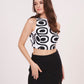 Square-shaped crop top with bold abstract print, paired with black thigh-high slit skirt for a striking ensemble