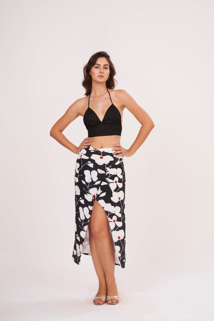 Black halter neck top and floral skirt with captivating front opening and alluring center gap, perfect for beach vacations and showcasing curves.