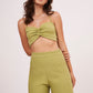Elegant green halter neck bralette with ruched detailing and tie-up closure, part of a chic co-ord set for confidence and style.