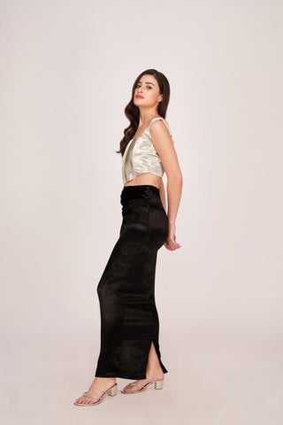 The side profile highlights the fitted structure of the metallic bodice and the elegant, fluid drape of the skirt, perfect for a high-fashion statement.