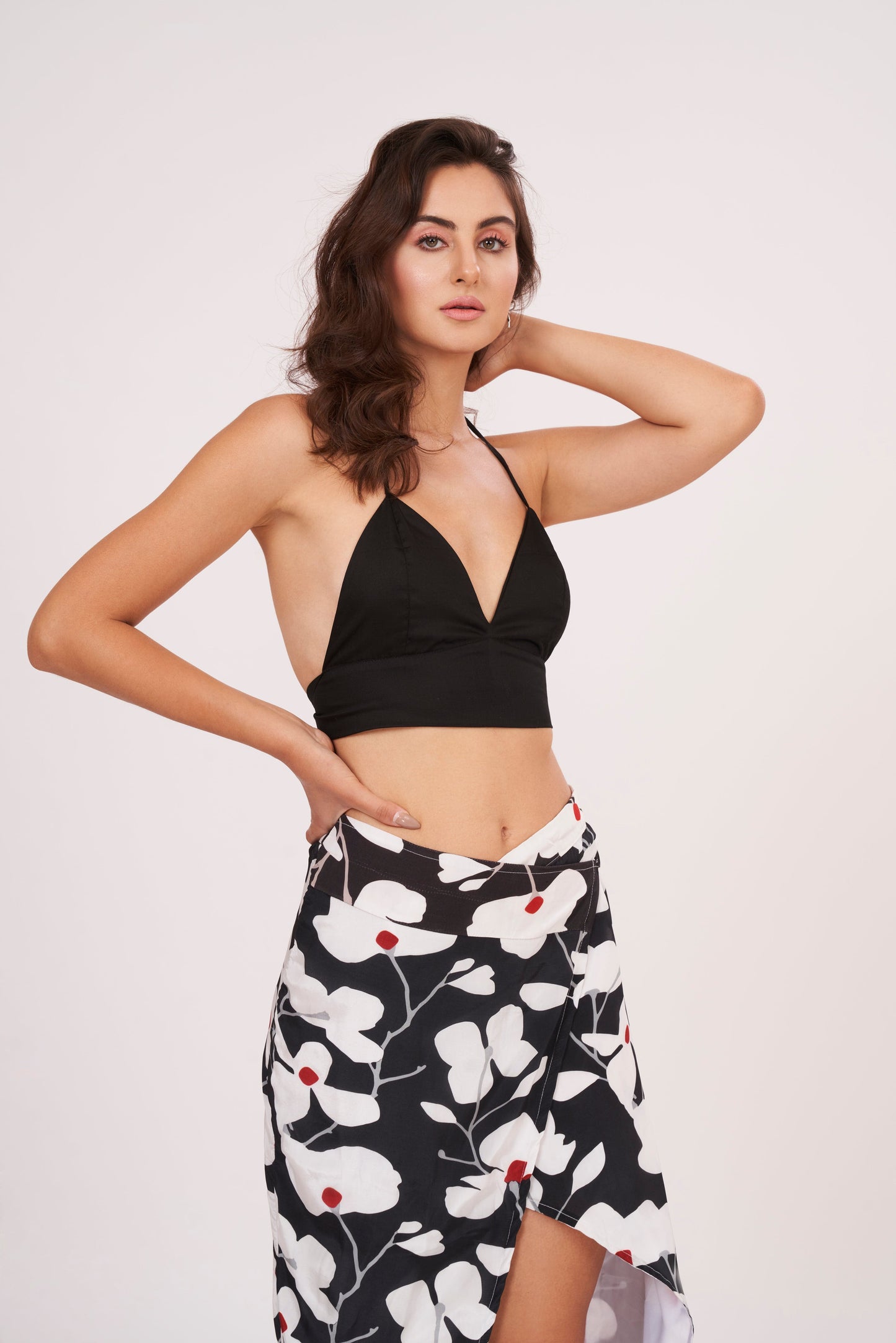 Black halter neck top and floral skirt with captivating front opening and alluring center gap, perfect for beach vacations and showcasing curves.