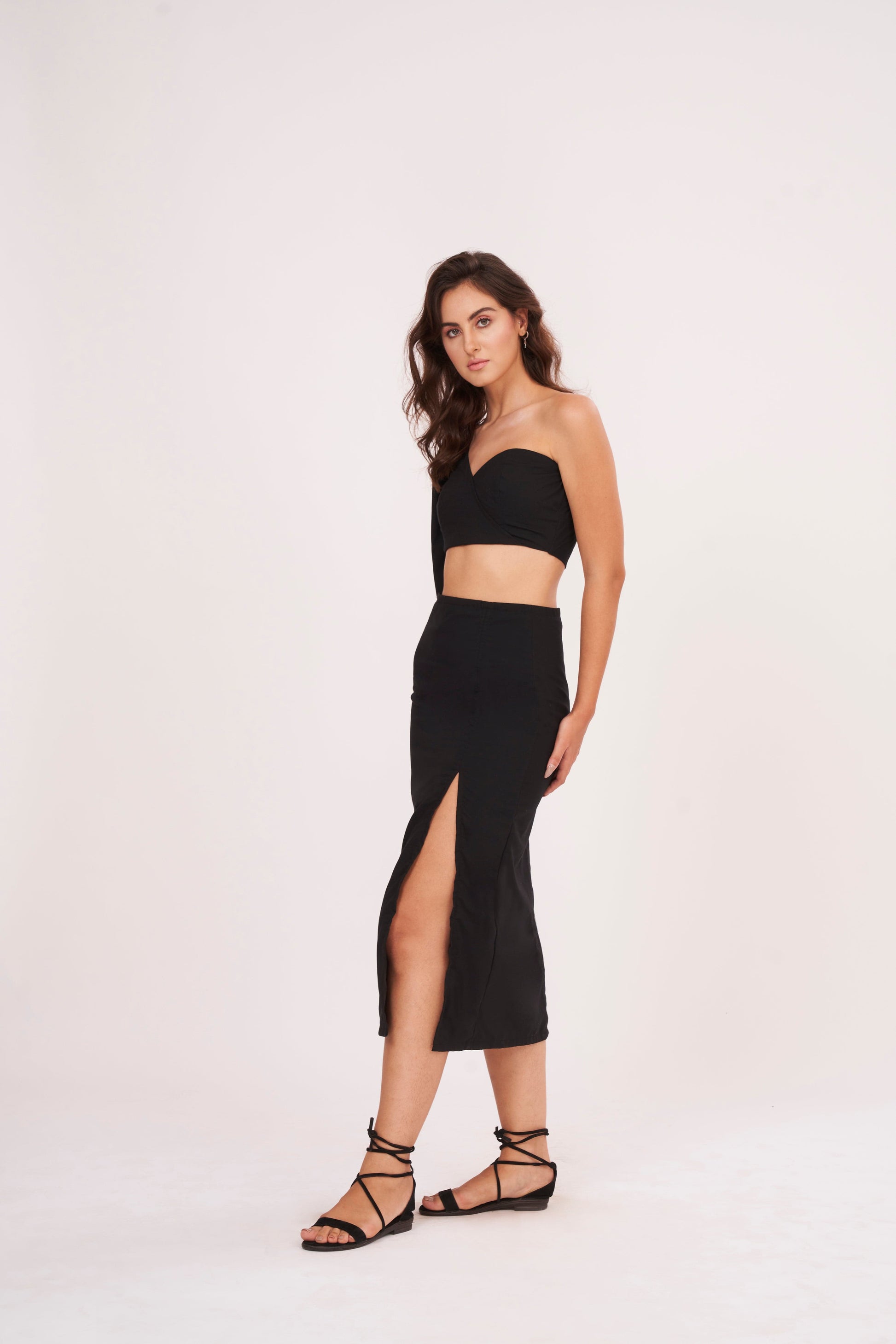 Elegant high-waisted black muslin skirt with thigh-high slit, offering sophistication and glamour for chic occasions