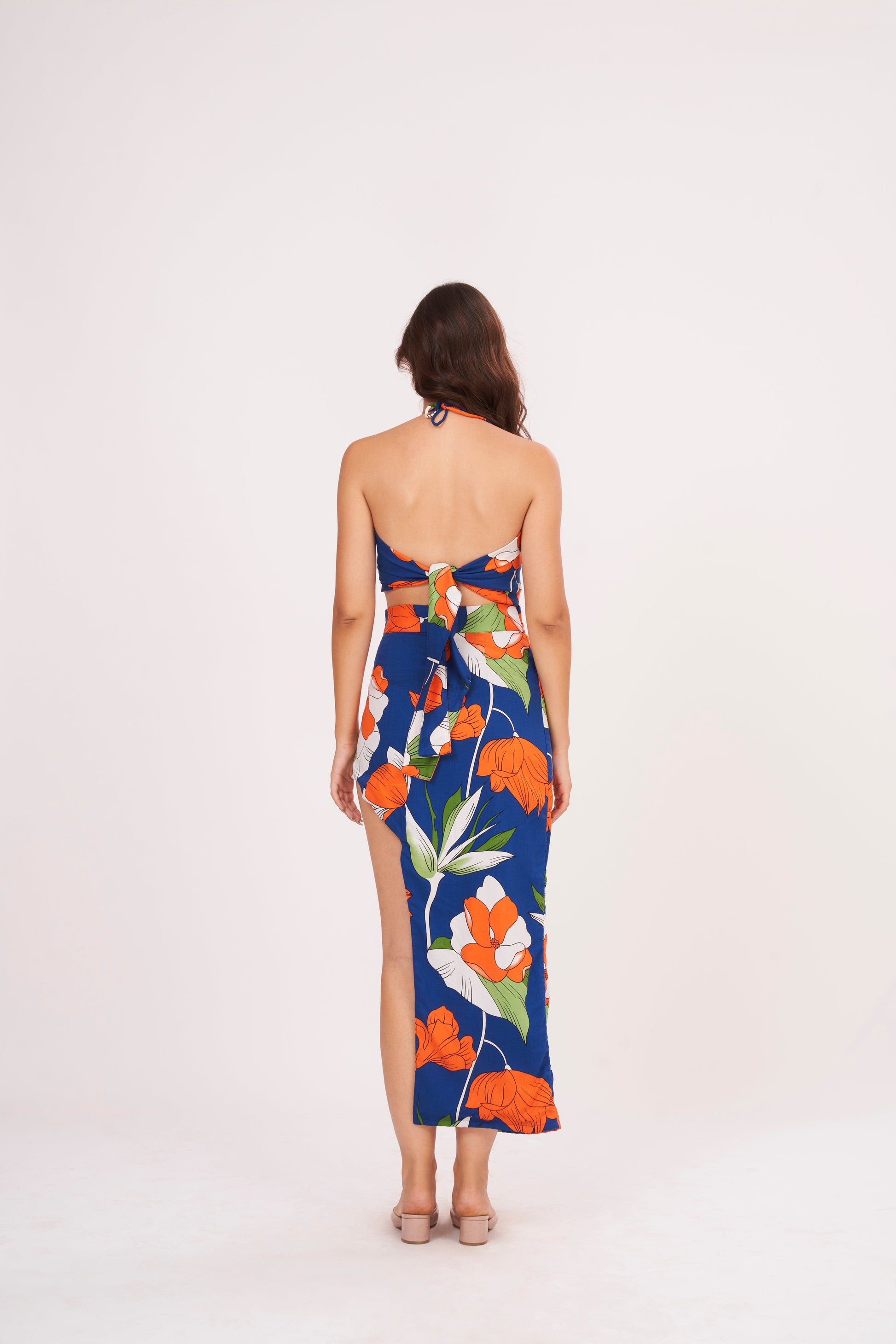 Long floral skirt with sultry thigh-high slit, crafted from high-quality muslin for comfort and durability.