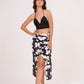 Black halter neck top and floral skirt with captivating front opening and alluring center gap, perfect for beach vacations and showcasing curves.