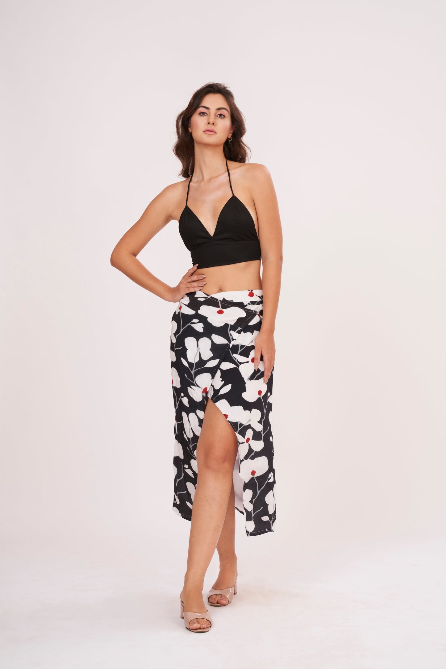 Black halter neck top and floral skirt with captivating front opening and alluring center gap, perfect for beach vacations and showcasing curves.