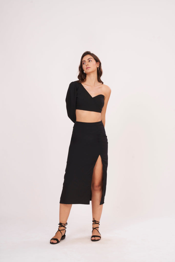 Elegant high-waisted black muslin skirt with thigh-high slit, offering sophistication and glamour for chic occasions