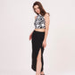 Square-shaped crop top with bold abstract print, paired with black thigh-high slit skirt for a striking ensemble