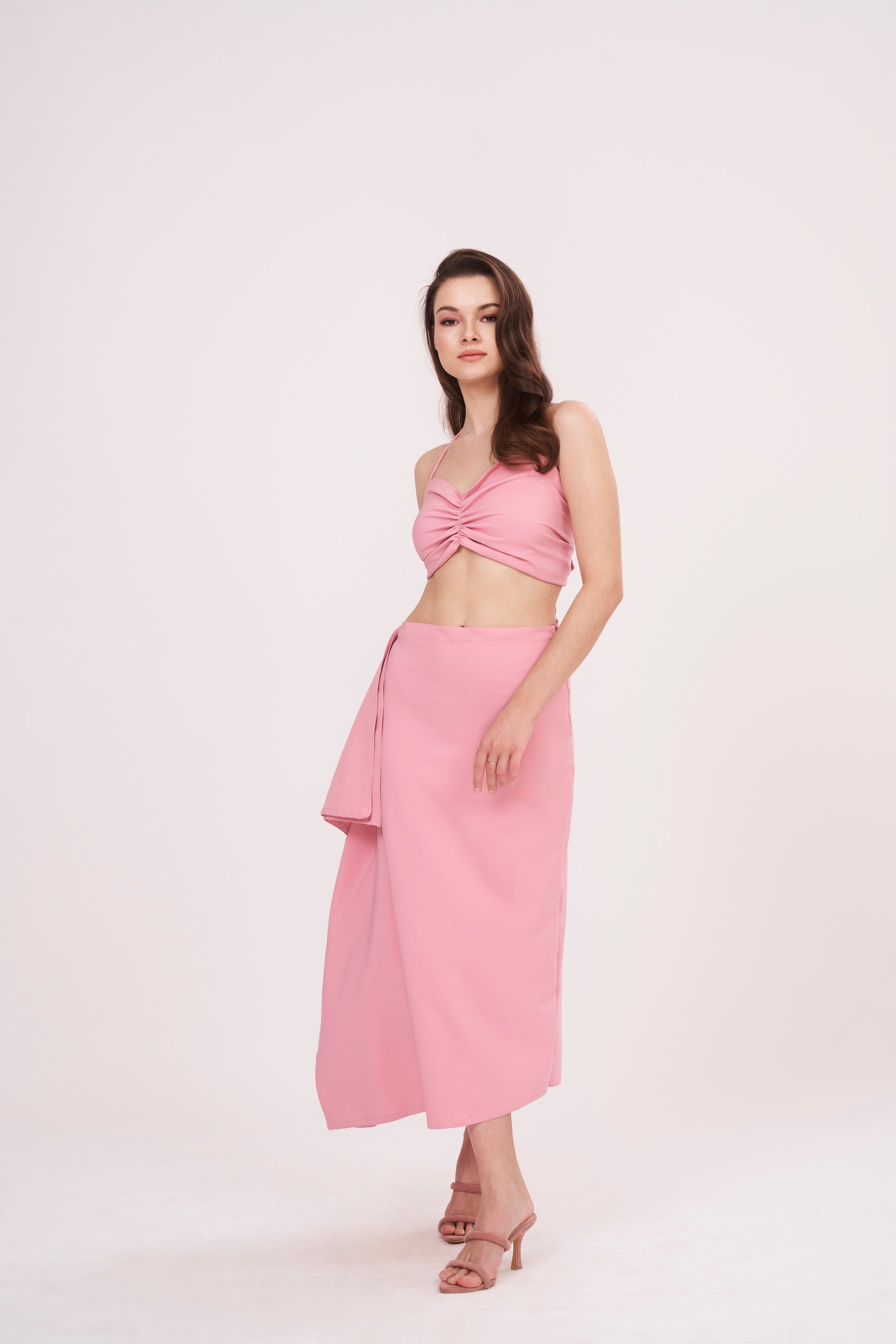 Tie-back crop top with ruched design and delicate pink hue. Ideal for any occasion. Can be paired with matching skirt or mixed and matched for a unique look.