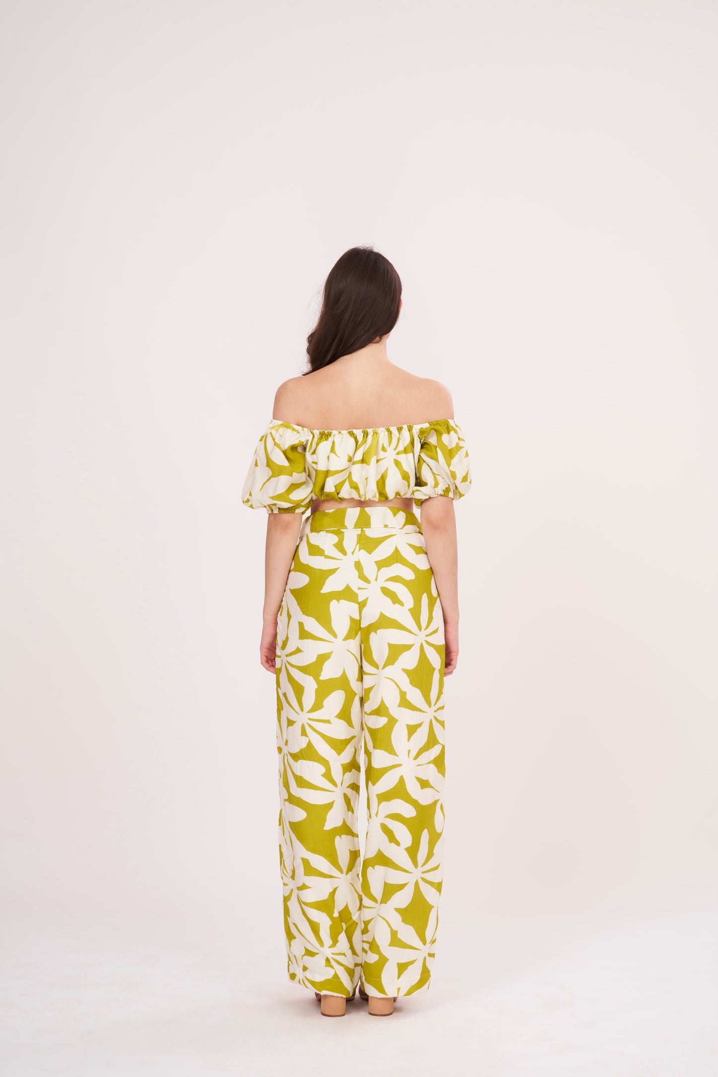 Green geometric print, loose-fit, wide-legged flowy trousers perfect for a breezy, relaxed feel during summer.