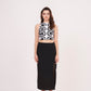 Square-shaped crop top with bold abstract print, paired with black thigh-high slit skirt for a striking ensemble