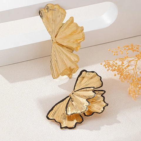 A beautiful example of nature-inspired jewelry, these gold-toned petal earrings provide a timeless and feminine aesthetic, making them a versatile gift