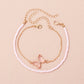 This handcrafted pink butterfly anklet combines earthy beads with a whimsical charm, making it an ideal accessory to brighten up your vacation wardrobe