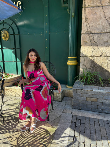 Vibrant oversized floral print dress with graceful movement and modern scarf detail