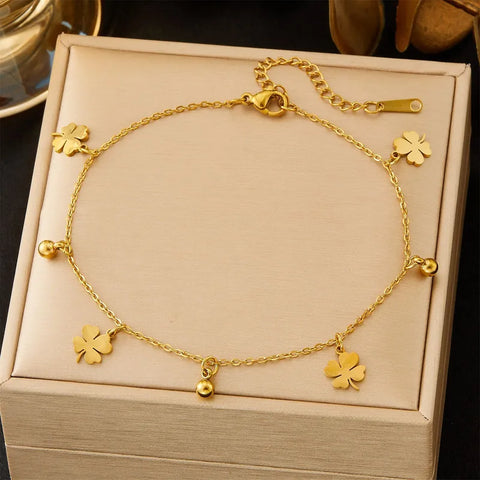 A high-quality titanium anklet featuring polished gold petal charms and beads, an elegant accessory for summer evenings or dressy occasions.