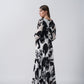Back view of an ankle-length crepe dress with long sleeves and a flowing fit