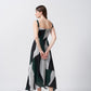 Back view of a green, black, and grey abstract print crepe midi dress with a flowing fit