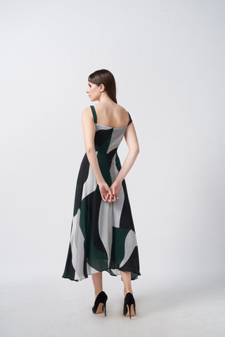 Back view of a green, black, and grey abstract print crepe midi dress with a flowing fit