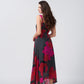 Back view of a pink and black floral print chinon midi dress with a flowing fit