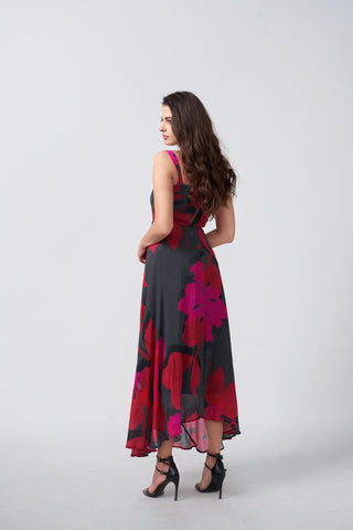 Back view of a pink and black floral print chinon midi dress with a flowing fit