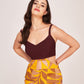 Close-up of model in maroon and multicolour satin midi dress highlighting V-neckline and shoulder straps.