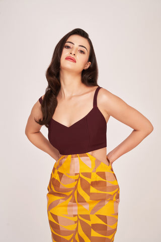 Close-up of model in maroon and multicolour satin midi dress highlighting V-neckline and shoulder straps.